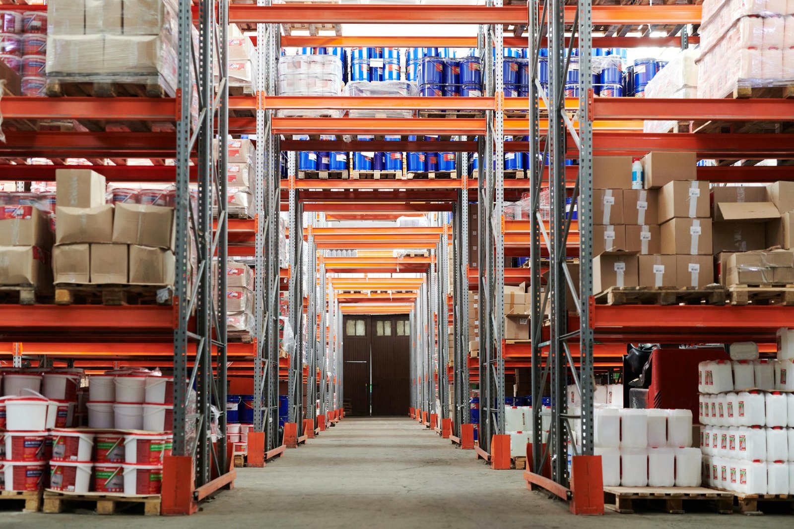 service-1 Wide angle view of a warehouse with stocked shelves and boxes.